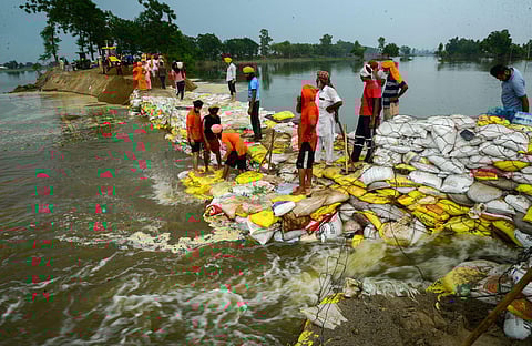 Volunteers make an embankment in a flooded area after the breach in the Sutlej river, in Jalandhar district, Saturday, July 15, 2023. (Photo | PTI)