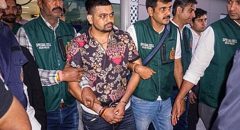 Gangster Deepak 'Boxer', a wanted fugitive in India, centre .(File Photo | PTI)