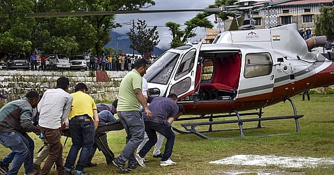 An injured being airlifted to AIIMS Rishikesh after an accident at a Namami Gange project site in Chamoli district. (Photo | PTI)
