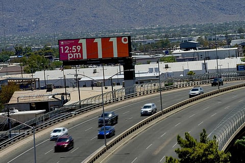 A digital billboard displays an unofficial temperature, Monday, July 17, 2023, in downtown Phoenix. (Photo | AP)