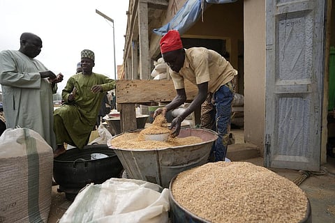 A man sells grain in Dawanau International Market in Kano Nigeria, Friday, July 14, 2023. (AP)