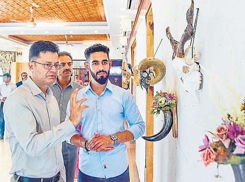 Artist Aziz-ur Rehman (right) at an exhibition showcasing his work at Kashmir Arts Emporium in Srinagar  | Express