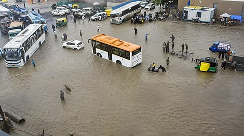 Vehicles wade through the waterlogged Ring Road after monsoon rains, in Rajkot, Gujarat on July 12, 2022. (Photo | PTI)