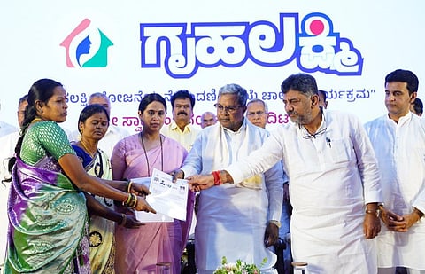 CM Siddaramaiah and DyCM DK Shivakumar launch the registration process for the Gruha Lakshmi scheme in Bengaluru on Wednesday. (Photo | Express)