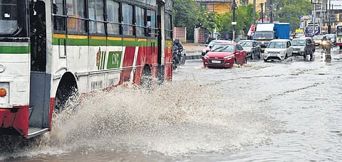 A bus splashes water at Karkhana, Secunderabad, on Thursday. (Photo | Express)