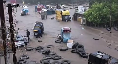 Vehicles pass through a waterlogged road after heavy monsoon rainfall, in Junagadh. (Photo | PTI)