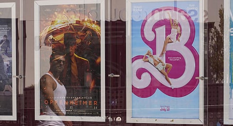 Advertisements for the films 'Oppenheimer,' from left, and 'Barbie,'.(Photo | AP)