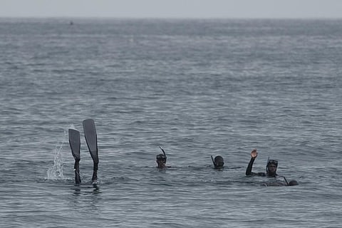 Rescuers search in the water after a boat capsized leaving several deaths at a beach in Dakar, Senegal. (Photo | AP)