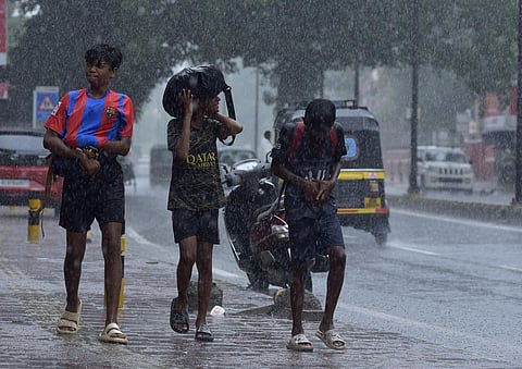 Three boys walk home drenched after their football practice in Kochi. (Photo | A Sanesh, EPS)