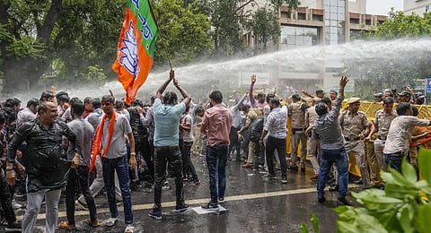 Police personnel use water cannon to disperse BJP workers during a protest against Delhi Chief Minister Arvind Kejriwal. (Photo | PTI)