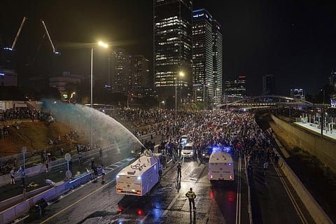Riot police try to clear demonstrators with a water canon during a protest against the Netanyahu government's move to overhaul the judicial system, in Tel Aviv, July 24, 2023. (Photo | AP)