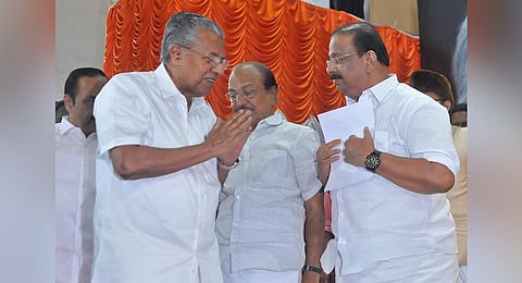 Chief Minister Pinarayi Vijayan and Congress state president K Sudhakaran greet each other as the former arrives for the Oommen Chandy commemoration meeting in Thiruvananthapuram. (Photo | B P Deepu)