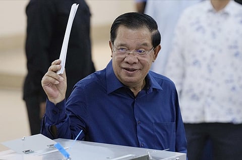 FILE- Cambodian Prime Minister Hun Sen raises a ballot before voting at a polling station at Takhmua in Kandal province, southeast Phnom Penh, on July 23, 2023. (Photo | AP)