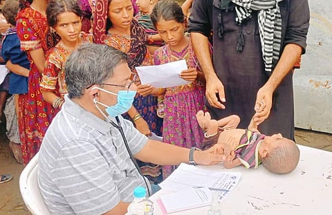 Dr. Jayesh Kapadia treating kids at the Medical camp.
