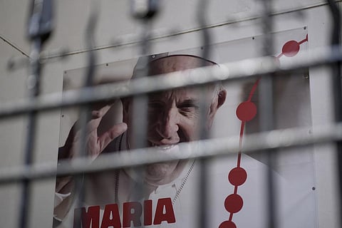 A poster showing a picture of Pope Francis and announcing World Youth Day 2023 hangs outside a church in Lisbon, Tuesday, July 25, 2023. (Photo | AP)