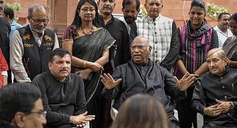 AAP MP Sanjay Singh with Leader of Opposition in Rajya Sabha Mallikarjun Kharge and other opposition MPs during a protest in Parliament complex. (Photo | PTI)