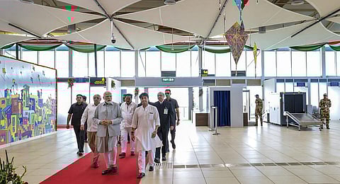 Prime Minister Narendra Modi with Union Minister for Civil Aviation Jyotiraditya Scindia and Gujarat Chief Minister Bhupendra Patel at the newly-inaugurated Rajkot International Airport. (Photo| PTI)