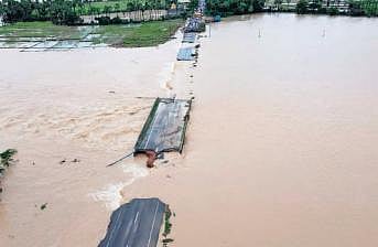 Only parts of a bridge remain in Nainpaka village on Thursday due to the floods following the relentless rains over the past week