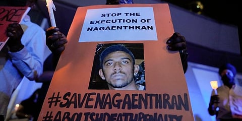 FILE - Activists hold posters against the impending execution of Nagaenthran K. Dharmalingam.  Nagaenthran was executed in Nov, 2022 for trafficking heroin into Singapore. (Photo | AP)