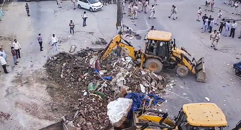 Bulldozers being used to demolish illegal structures during an anti-encroachment drive by PWD, at Bhajanpura area in New Delhi. (Photo | PTI)