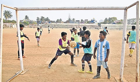 Children playing football at Kanikapuram playground in Thiru Vi Ka Nagar | express