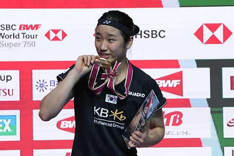 South Korea's An Se-young kisses her gold medal during the medal ceremony for the women's singles after defeating China's He Bing Jiao in the Japan Open badminton tournament. (Photo | AP)