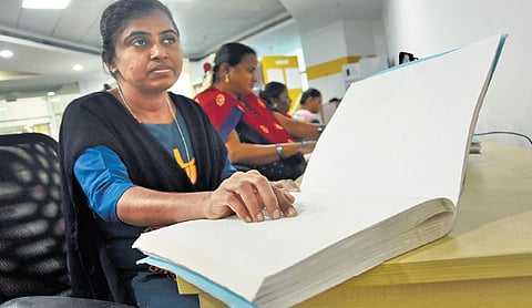 A visually impaired woman reads a Braille script in the exclusive Braille section at  the Anna Centenary Library in Kottupuram in Chennai | ashwin prasath