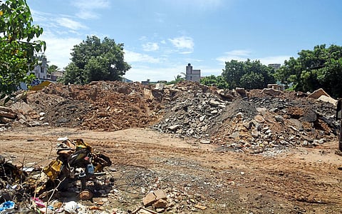 Construction debris dumped around Retteri lake in Kolathur. (Photo | P Ravikumar)