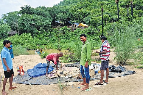 Tribals seen erecting tents on a hillock near Talluru in ASR district I Express