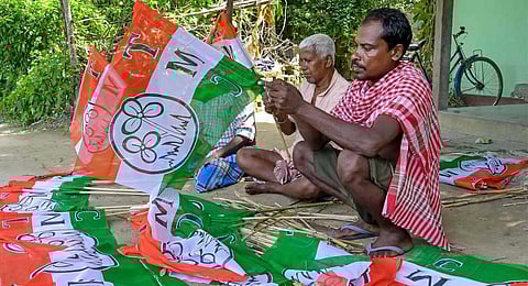 Workers prepare flags of Trinamool Congress for campaigning ahead of West Bengal panchayat elections, in Nadia, Monday, July 3, 2023. (PTI)