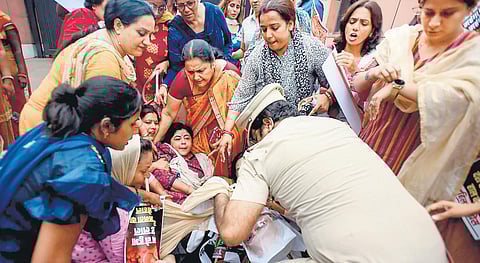 Police remove Mahila Congress workers protesting against inflation outside the BJP headquarters in New Delhi on Tuesday. (Photo | PTI)