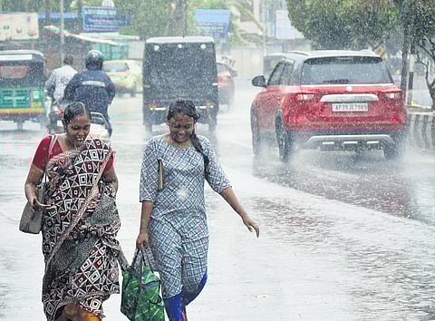 People go about their business even as rain lashes Vijayawada | Prasant Madugula