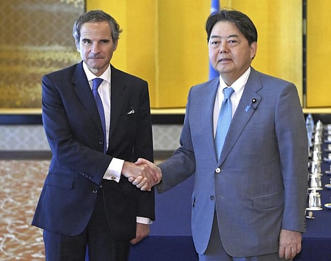 International Atomic Energy Agency head Rafael Mariano Grossi shakes hands with Foreign Minister Yoshimasa Hayashi before their meeting at the Iikura guesthouse in Tokyo. (Photo | AP)