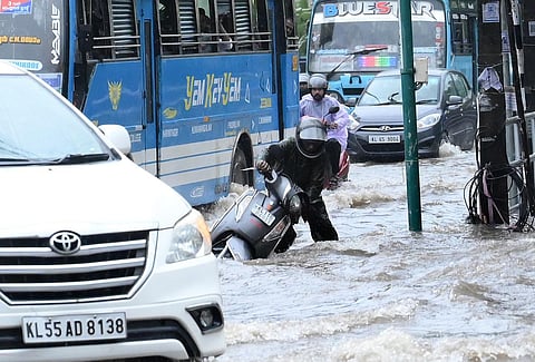 A two wheeler rider struggling to negotiate the waterlogged road following heavy rains at Stadium Junction Road in kozhikode on Tuesday. (Photo | E Gokul, EPS)