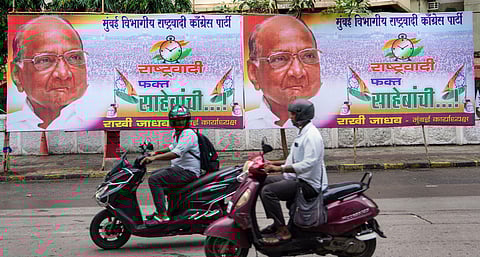 Representational Image: Commuters move past NCP chief Sharad Pawar's hoardings, in Mumbai, Wednesday, July 5, 2023. (Photo | PTI)