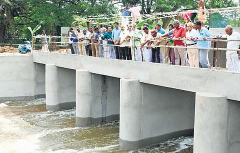 Officials and farmers welcoming the Cauvery river at Nallambal regulator, on Thursday | Express