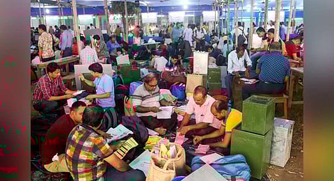 Polling officials collect ballot boxes and other election material at a distribution centre ahead of the West Bengal panchayat elections, at Balurghat in South Dinajpur district.(Photo | PTI)