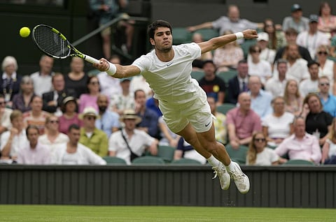 Spain's Carlos Alcaraz returns to Chile's Nicolas Jarry in a men's singles match on day six of the Wimbledon tennis championships in London. (Photo | AP)
