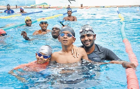 Head coach Sathishsivakumar and children in midst of their swimming lessons | Ashwin Prasath