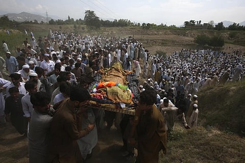 Relatives and mourners carry the casket of a victim who was killed in Sunday's suicide bomber attack in the Bajur district of Khyber Pakhtunkhwa, Pakistan. (Photo | AP)