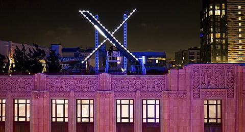 Workers install lighting on an 'X' sign atop the company headquarters, formerly known as Twitter, in downtown San Francisco.(File Photo | AP)