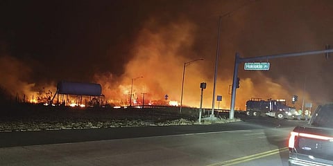 fire and smoke filling the sky from wildfires on the intersection at Hokiokio Place and Lahaina Bypass in Maui, Hawaii. (Photo |AP)