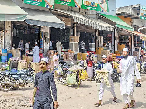 Locals at a market after curfew was relaxed for a few hours, in Nuh on Thursday. (Photo | PTI)
