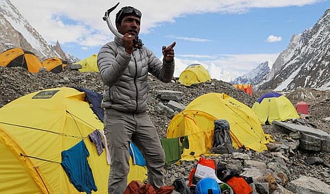 Sajid Ali Sadpara holds his climbing gear at K2 Basecamp, the world’s second-tallest mountain in the Karakoram range of Gilgit–Baltistan, Pakistan. (File Photo | AFP)