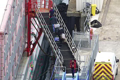 People board the Bibby Stockholm accommodation barge at Portland Port in Dorset. (Photo | AP)
