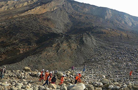 File photo of rescue workers at the site of a landslide in a jade mine in a remote region of Myanmar (File Photo | AFP)