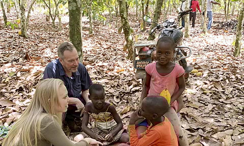 Executive Director Terrence Collingsworth and translator Melina Cardinal Bradette, talk to teenage children, ages 12 to 15, from Burkina Faso, who were working on a cocoa plantation. (Photo | AP)