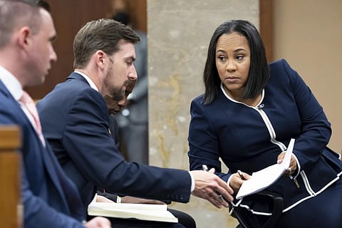 Fulton County District Attorney Fani Willis, right, talks with a  member of her team during proceedings to seat a special purpose grand jury in Fulton County, Georgia on May 2, 2022. (File Photo | AP)