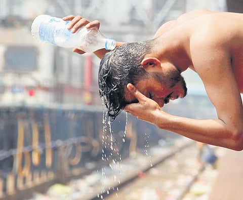 A man pours water on his head to beat the heat. Image used for representational purpose | G Satyanarayana