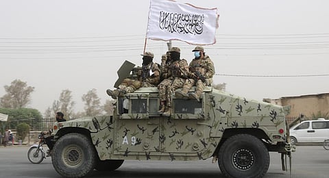 Taliban fighters patrol on the road during a celebration marking the second anniversary of the withdrawal of U.S.-led troops from Afghanistan, in Kandahar, south of Kabul. (Photo | AP)